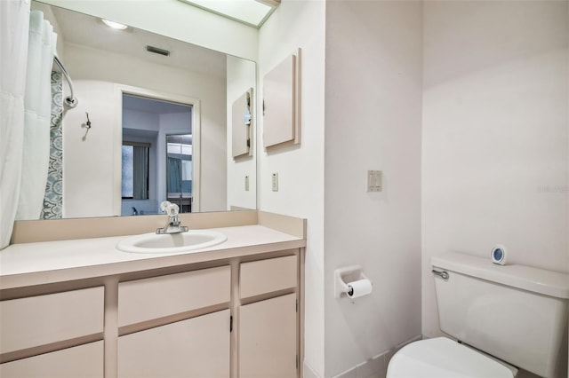 bathroom with vanity and toilet