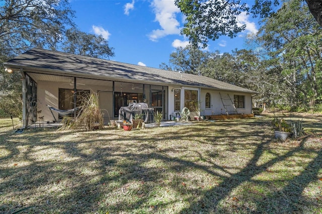 rear view of house featuring a lawn