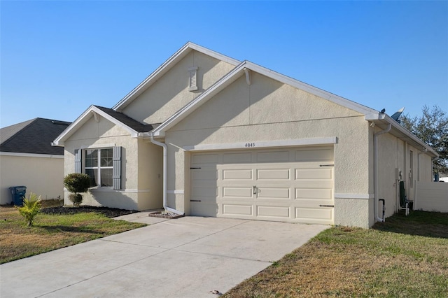 view of front of property with a garage and a front lawn