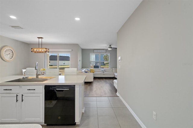 kitchen featuring white cabinets, ceiling fan with notable chandelier, sink, hanging light fixtures, and black dishwasher