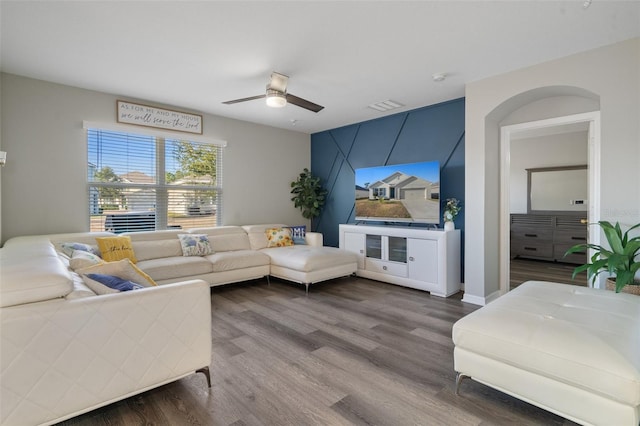 living room featuring hardwood / wood-style floors and ceiling fan