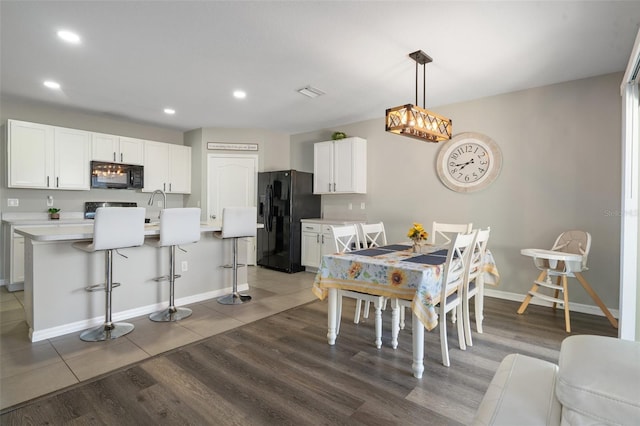 dining area with dark wood-type flooring and sink