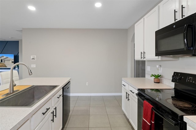 kitchen featuring white cabinets, light tile patterned floors, sink, and black appliances