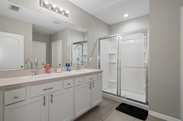 bathroom with tile patterned floors, vanity, and an enclosed shower