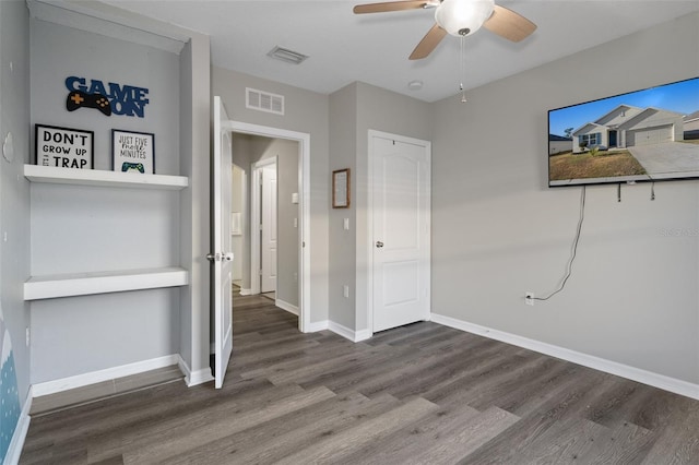 unfurnished bedroom featuring hardwood / wood-style floors and ceiling fan