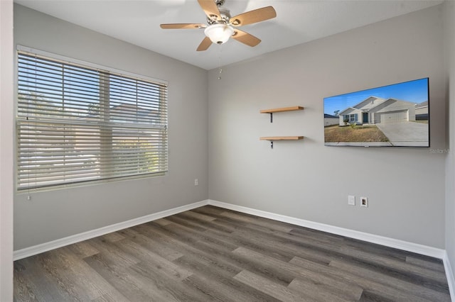 unfurnished room with ceiling fan and dark wood-type flooring