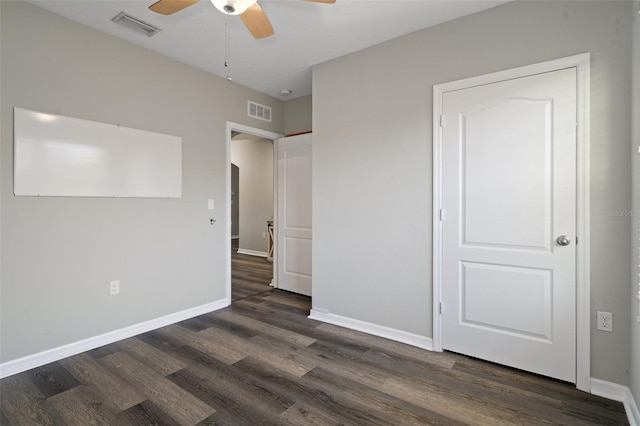 unfurnished bedroom featuring ceiling fan and dark wood-type flooring