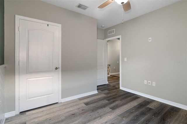 unfurnished bedroom with dark hardwood / wood-style floors and ceiling fan