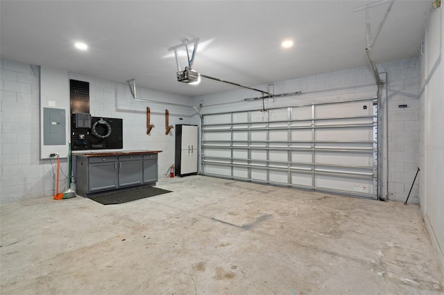 garage with electric panel and a garage door opener