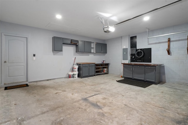 garage with electric panel and a garage door opener