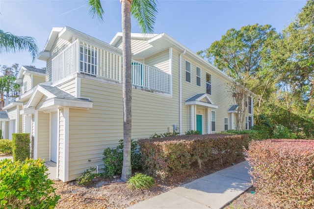 view of side of property with a balcony