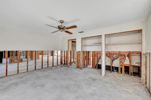 miscellaneous room with ceiling fan and concrete flooring