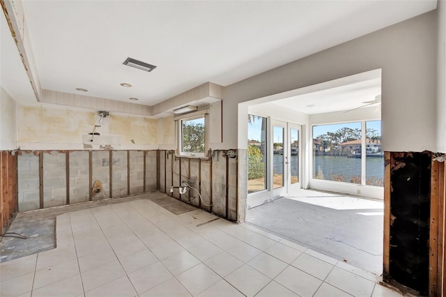 bathroom featuring a water view and ceiling fan