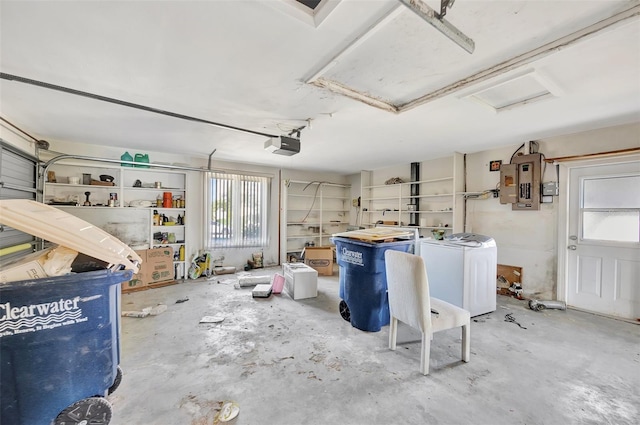 basement featuring electric panel and washing machine and clothes dryer