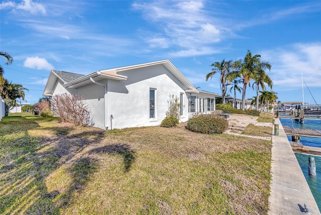 view of side of home featuring a yard