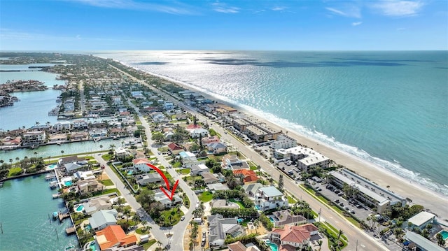 birds eye view of property with a water view and a view of the beach