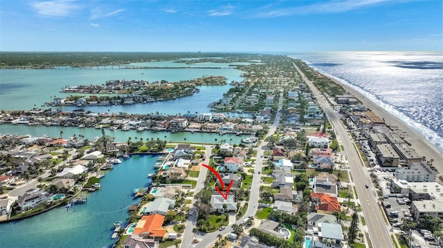 drone / aerial view featuring a water view and a view of the beach