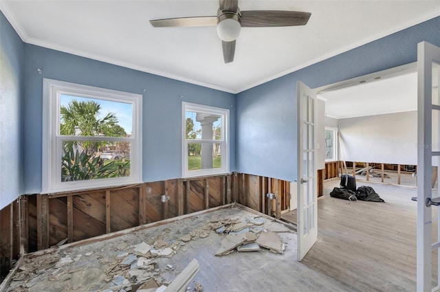 interior space featuring french doors, ceiling fan, crown molding, hardwood / wood-style flooring, and wood walls