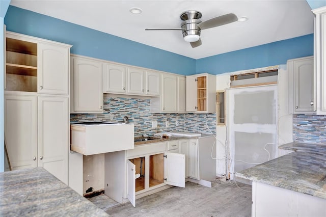 kitchen featuring decorative backsplash and white cabinetry