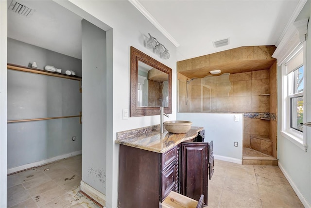 bathroom featuring vanity, crown molding, and a shower with shower door