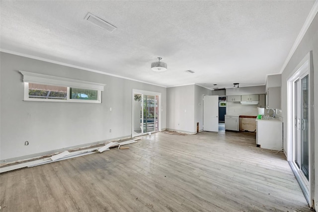 unfurnished living room featuring a textured ceiling, light wood-type flooring, and crown molding