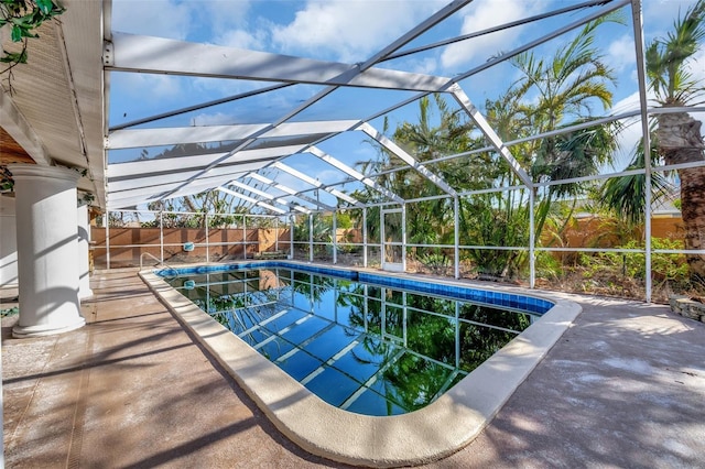 view of swimming pool with a lanai and a patio area