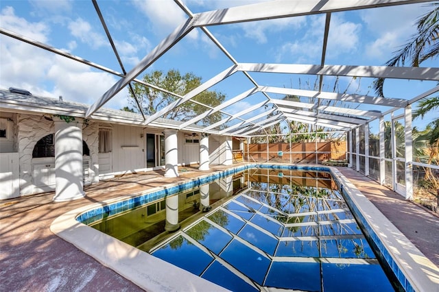 view of pool with a patio and a lanai