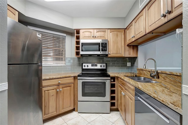 6923 Stonesthrow Cir N Unit 4105, Saint Petersburg, FL 33710 - kitchen featuring appliances with stainless steel finishes, light tile patterned flooring, tasteful backsplash, and light stone countertops