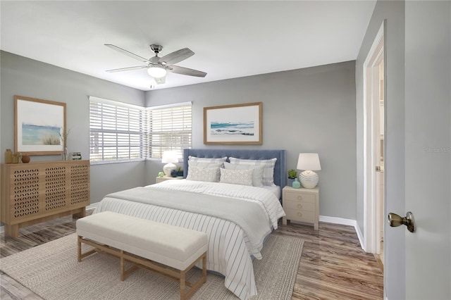 bedroom with ceiling fan and light hardwood / wood-style flooring