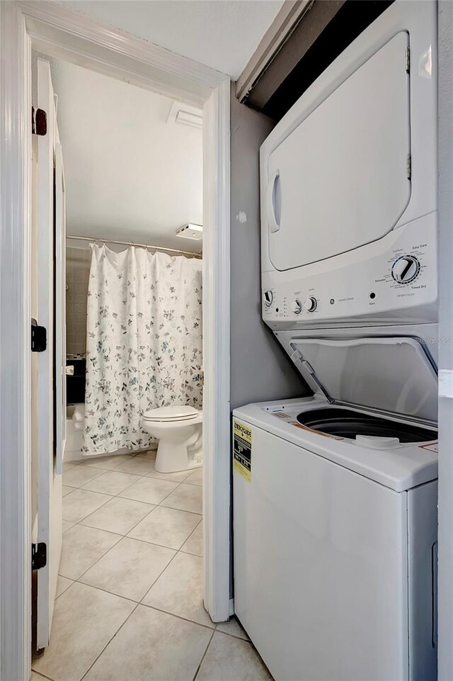 6923 Stonesthrow Cir N Unit 4105, Saint Petersburg, FL 33710 - washroom featuring estacked washer and dryer and light tile patterned floors