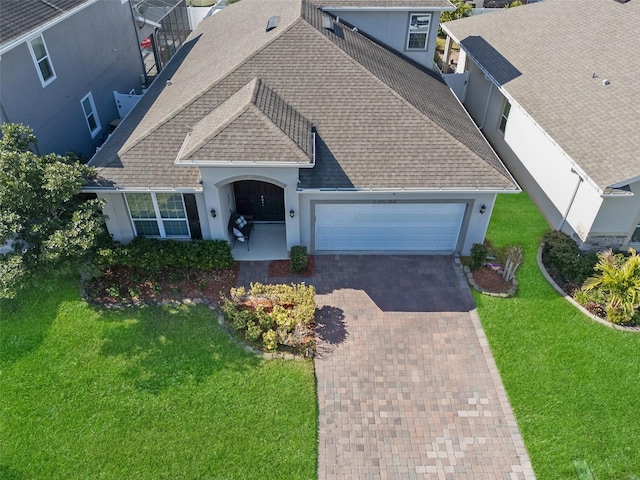 view of front facade with a garage and a front lawn