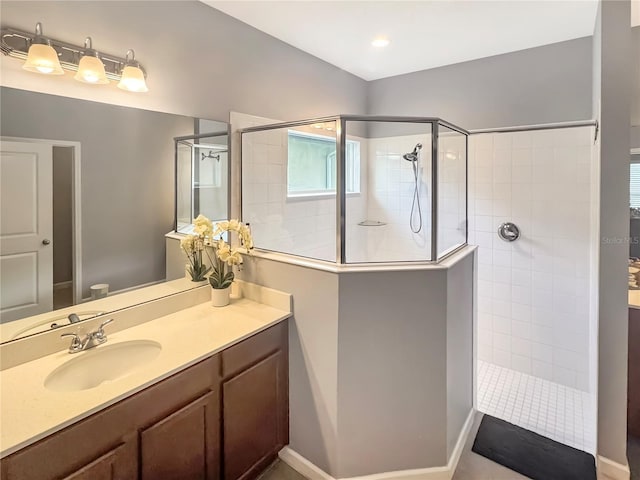 bathroom featuring a tile shower, vanity, and toilet