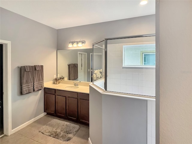 bathroom featuring tile patterned flooring, vanity, and walk in shower