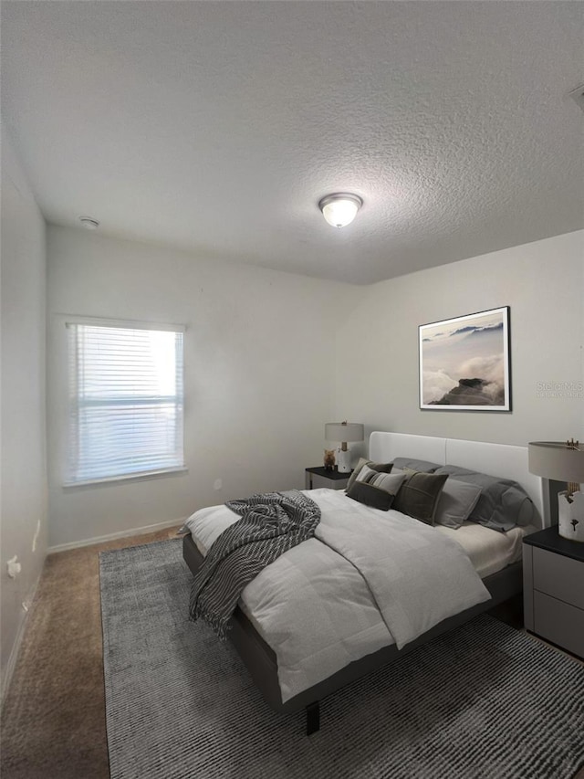 carpeted bedroom with a textured ceiling