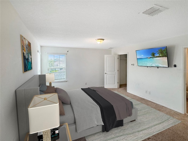 carpeted bedroom featuring a textured ceiling