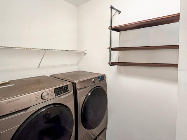 clothes washing area featuring washer and dryer