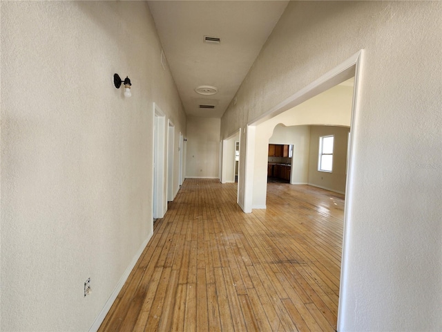 corridor with light hardwood / wood-style floors