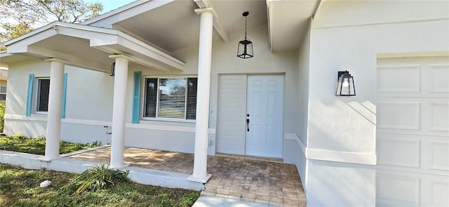 entrance to property with a porch and a garage