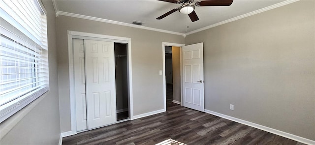 unfurnished bedroom featuring a closet, ceiling fan, dark hardwood / wood-style flooring, and crown molding