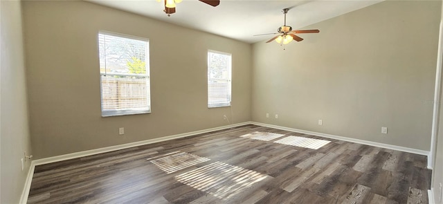 spare room featuring ceiling fan and dark wood-type flooring