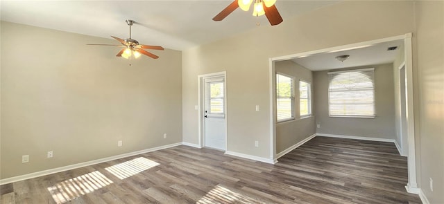 empty room with ceiling fan and dark hardwood / wood-style floors