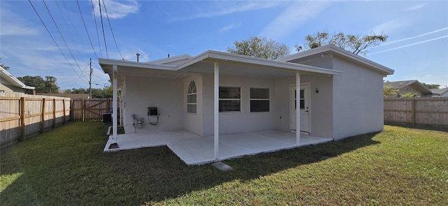 back of property featuring a yard and a patio area