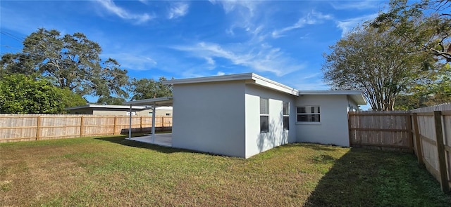 rear view of property featuring a lawn