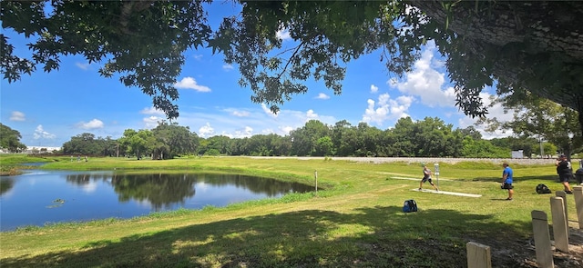 view of community featuring a yard and a water view