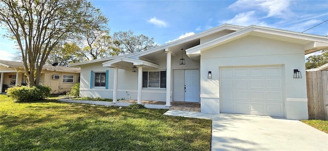 ranch-style house with a garage, a front lawn, and stucco siding