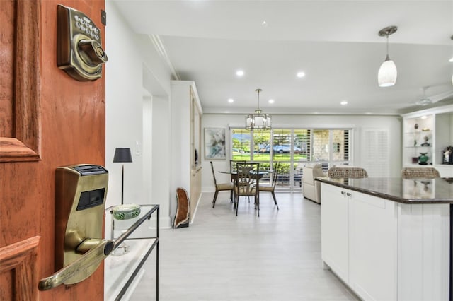 kitchen with recessed lighting, dark countertops, decorative light fixtures, and white cabinets