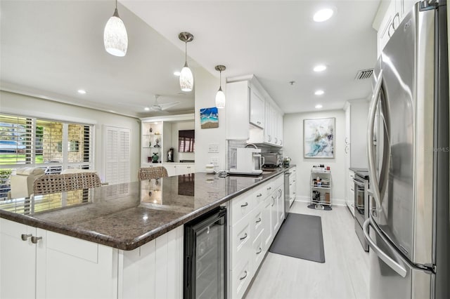 kitchen with ceiling fan, wine cooler, appliances with stainless steel finishes, white cabinetry, and recessed lighting