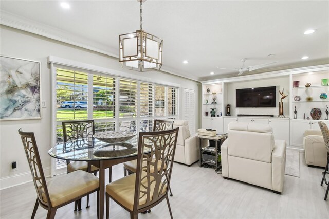 dining space featuring light wood-style floors, recessed lighting, and crown molding