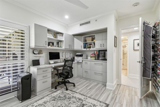 home office featuring wood tiled floor, visible vents, baseboards, and ornamental molding