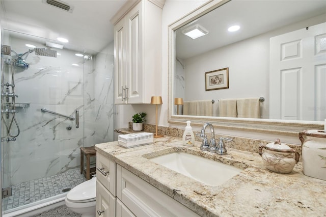 full bath featuring toilet, a marble finish shower, visible vents, and vanity